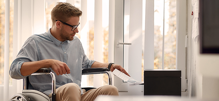 Person in wheelchair reviewing tax papers