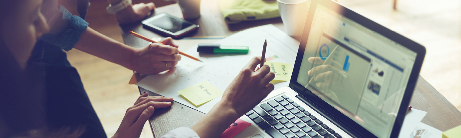 Financial planning, people discussing plans on a laptop